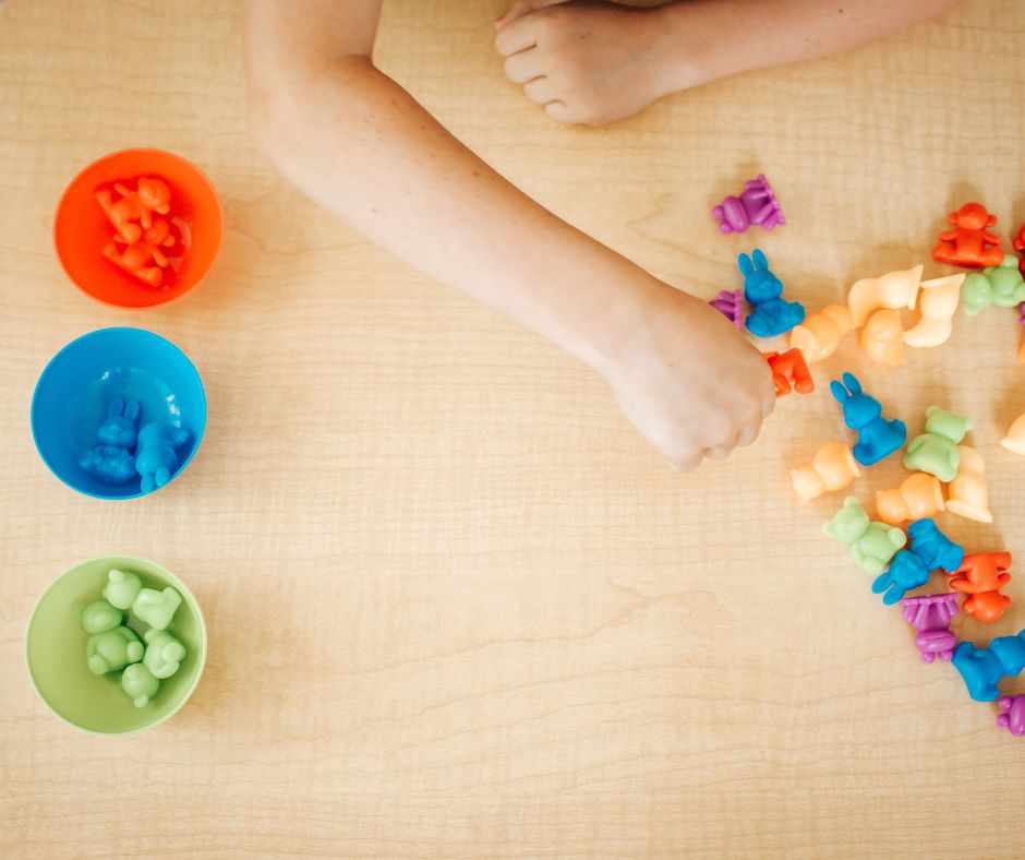 Child playing with color coordinated toys during occupational therapy session